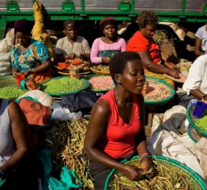 In between serving customers, the ladies sit and chat together in the sun.